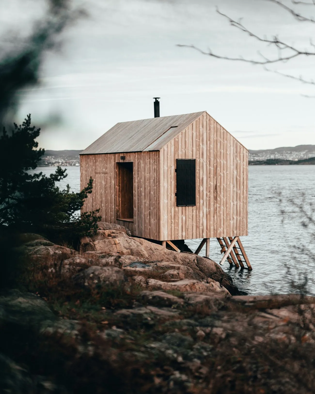 A wooden sauna on the rocky shore of the sea in Finland